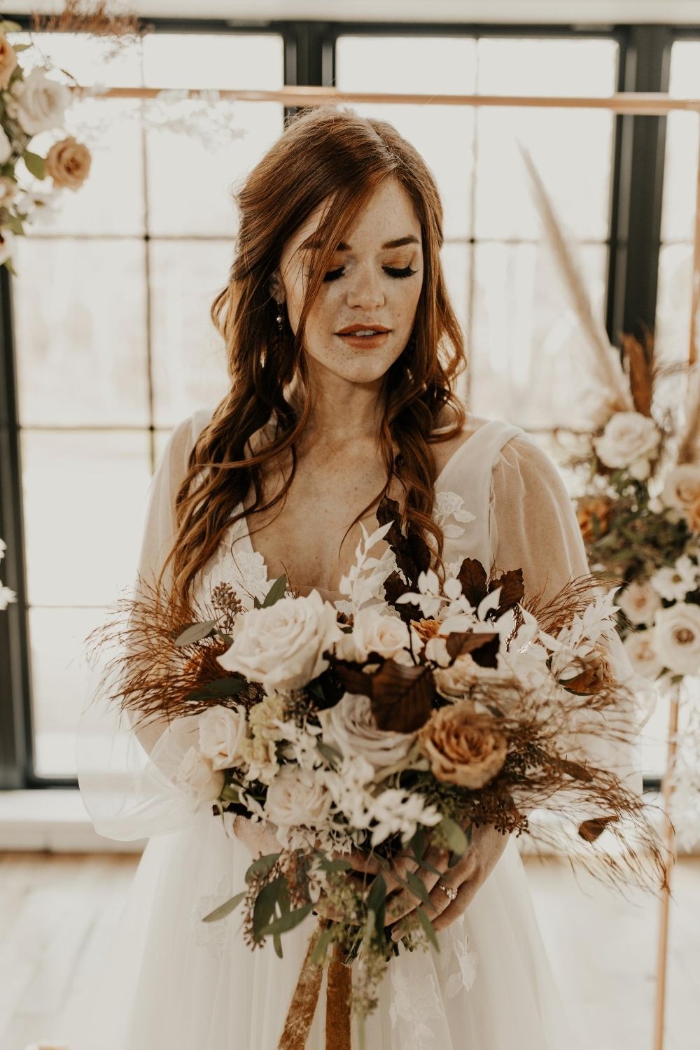 Bride with half up half down bohemian hairstyle in soft glam makeup