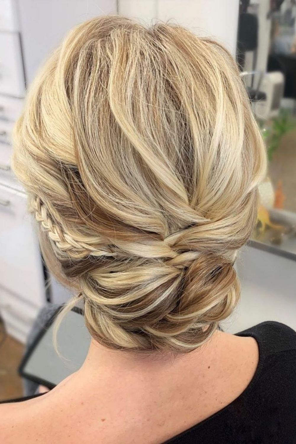 Bride with romantic textures soft waves updo hairstyle