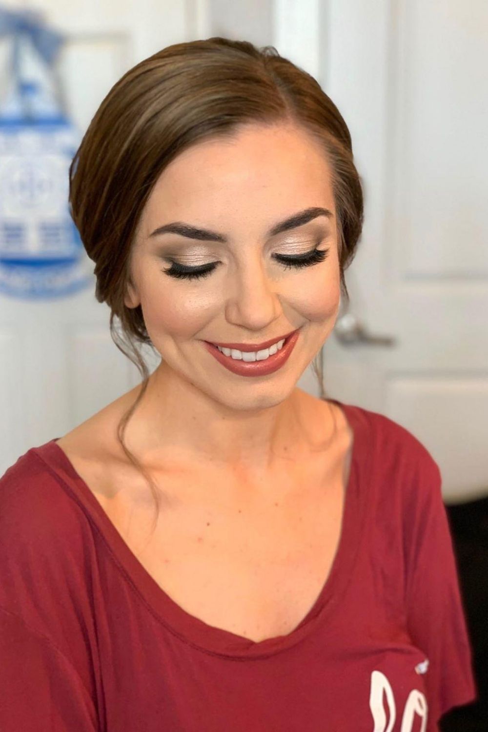 Bride with updo hairstyle in soft glam makeup with mauve lip color