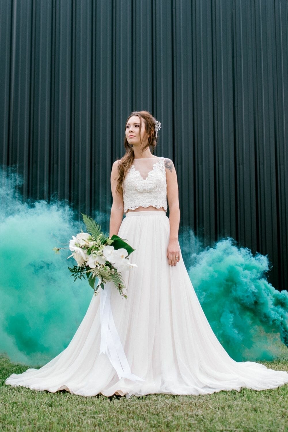 Bride standing in green mist background in Separates Wedding Dress photo by Sabel Moments Photography