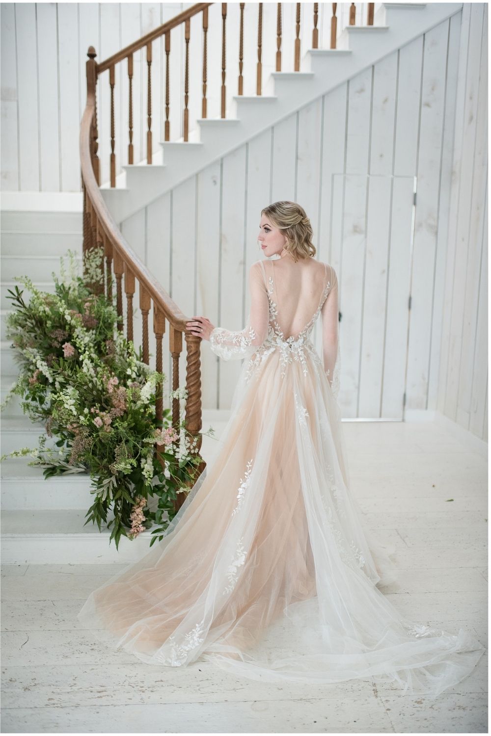 Bride in a coral A-line wedding dress with a low back