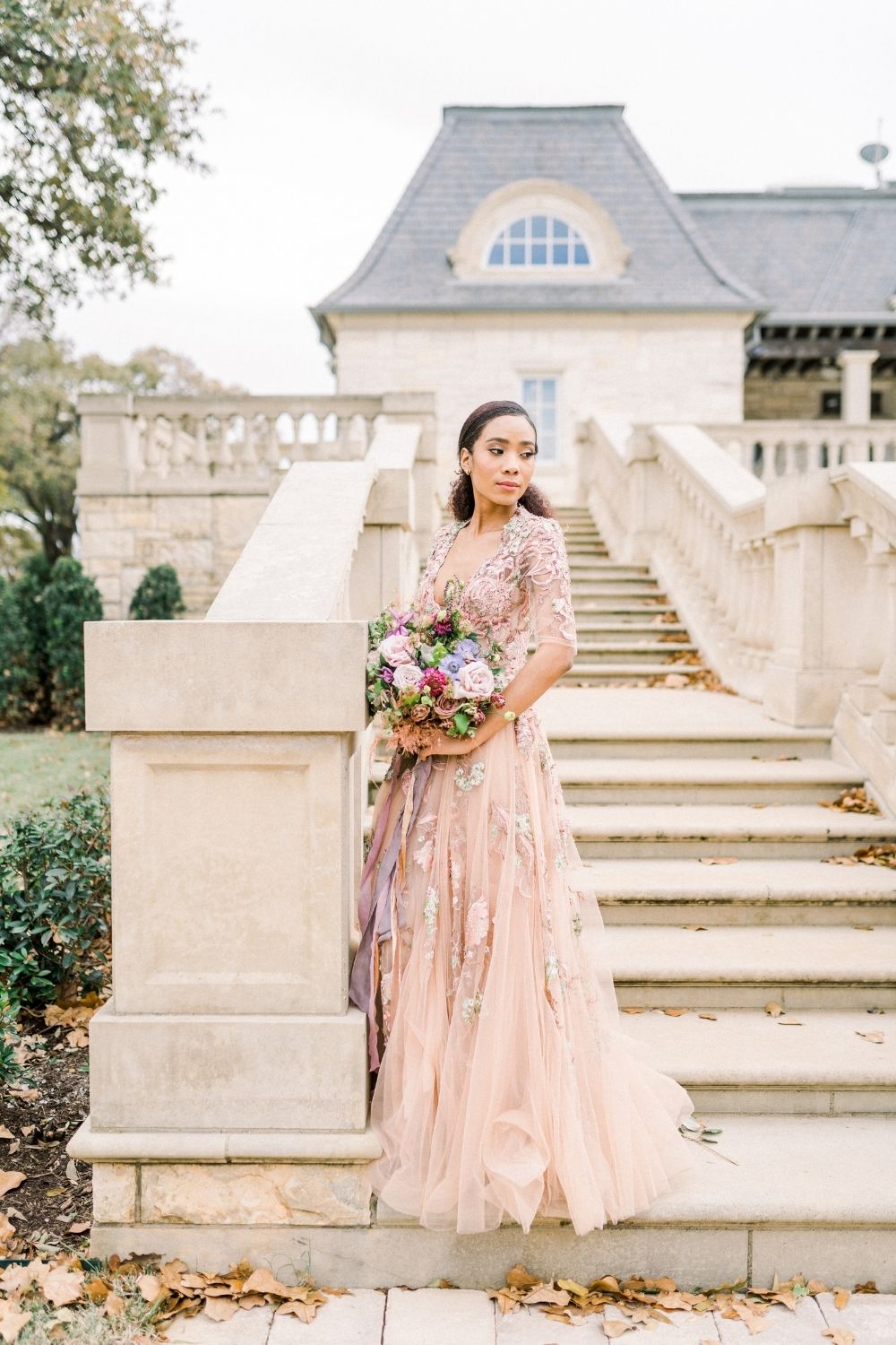Bride in a pink blush A-line wedding dress with floral details