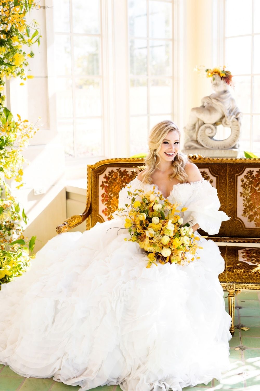 Bride in a white Ball gown wedding dress sitting on a gold chair