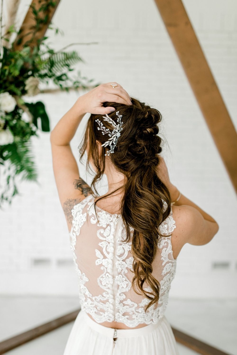 Bride in a white separates wedding dress top with a white hair pin