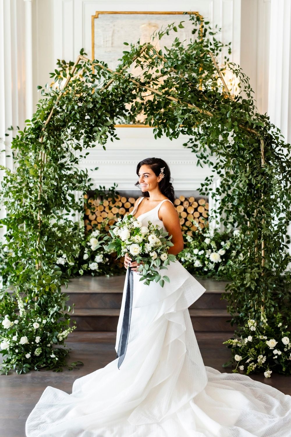 Bride in a white wedding gown with green and white bouquet
